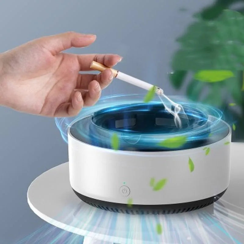 Grey intelligent electronic air purifier ashtray on a desk with cigarette butts in grooved tray.
