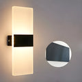 Black acrylic LED wall lamp with modern design mounted on wall