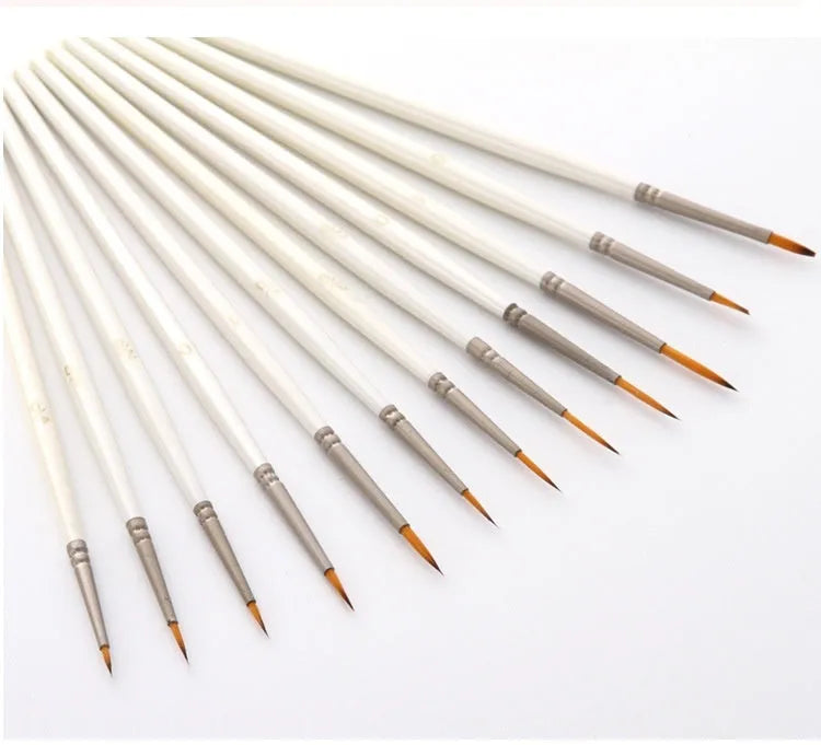 Set of 12 pearl white artist painting brushes with wooden handles and nylon wool fibres.