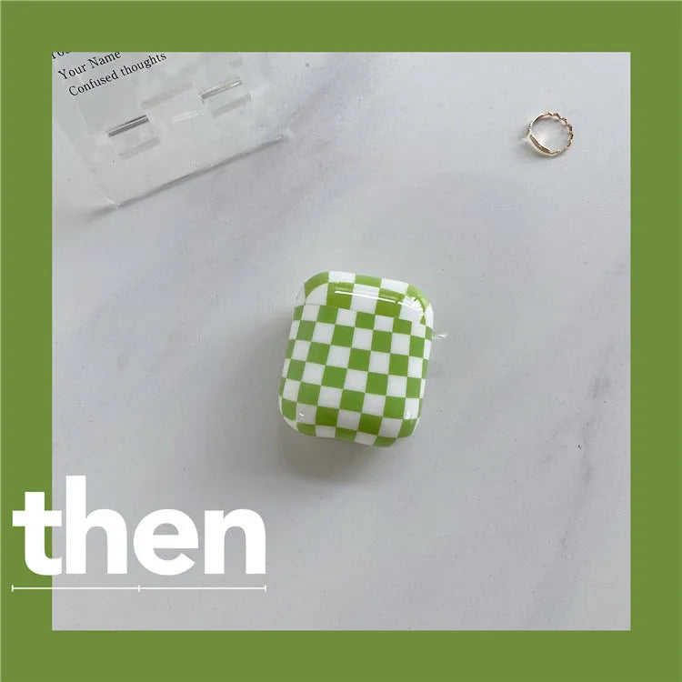 Black and green checkerboard pattern TPU protective case covers for Apple AirPods, one with a smiley face lanyard.