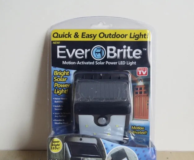 Two white solar-powered LED security lights with ground stakes for outdoor use.