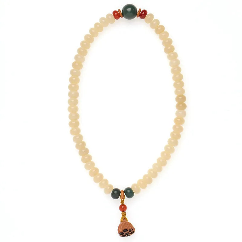 Cream Topaz Bodhi wooden bracelet with flat round beads on a wrist.