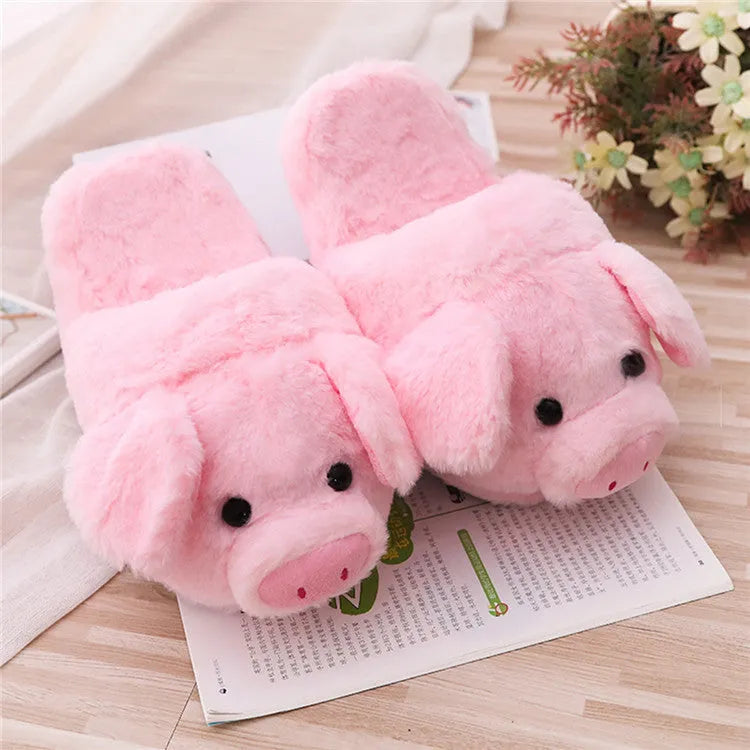 Pink pig-shaped plush floor slippers with short plush exterior.