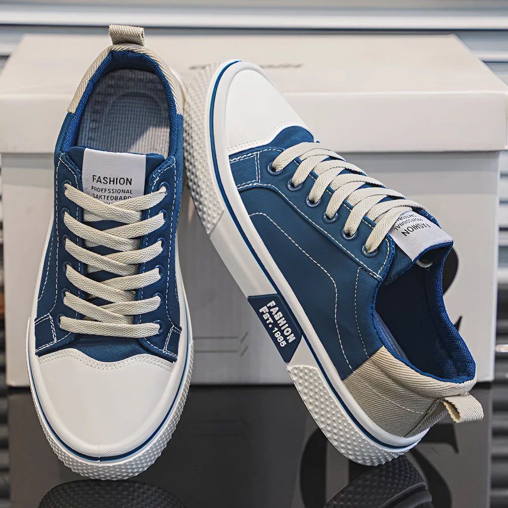 Men's low-top canvas casual shoe in blue with round toe, lace-up front, and soft PVC sole.