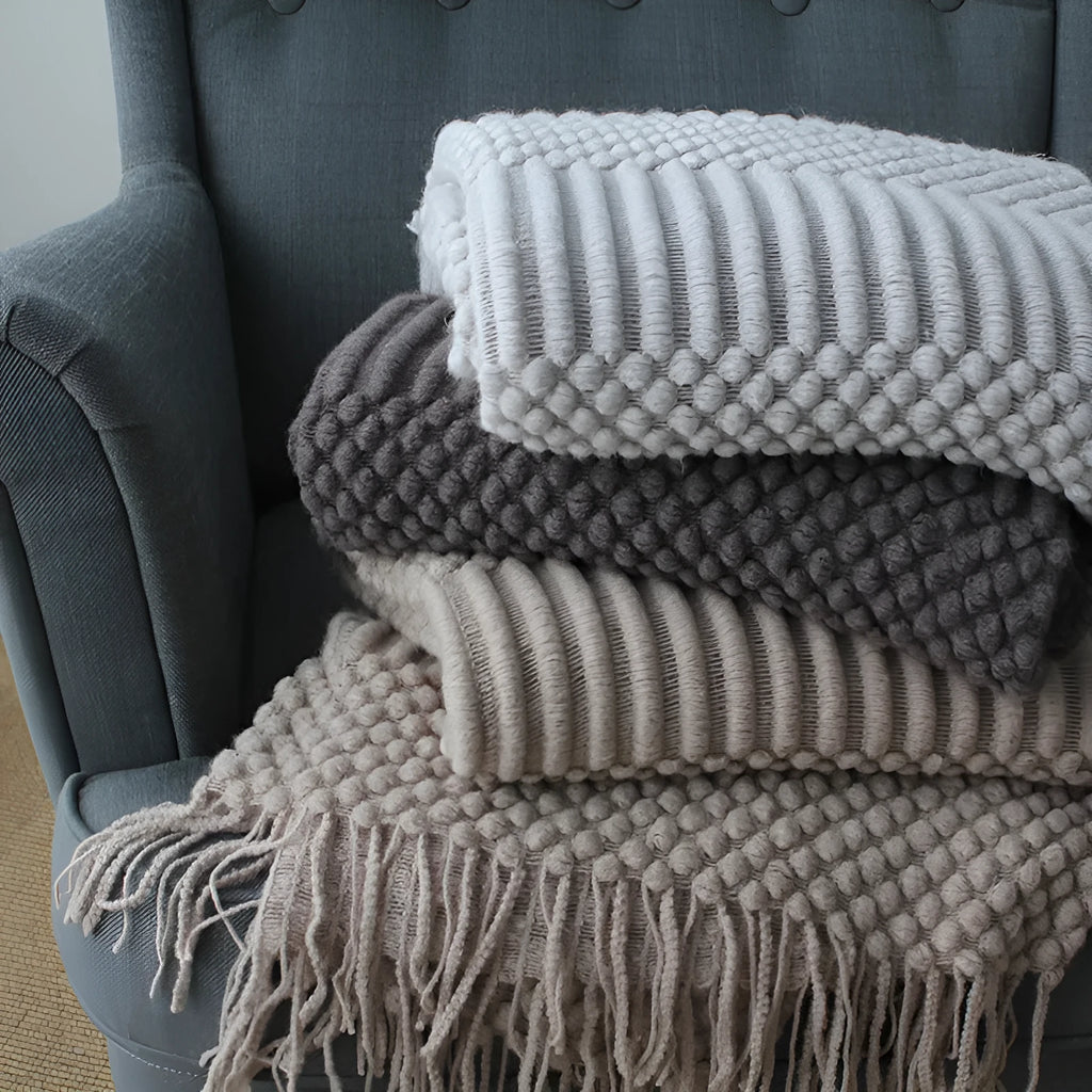 Small light grey polyester nap blanket folded, showing its texture and 127x170 cm size.