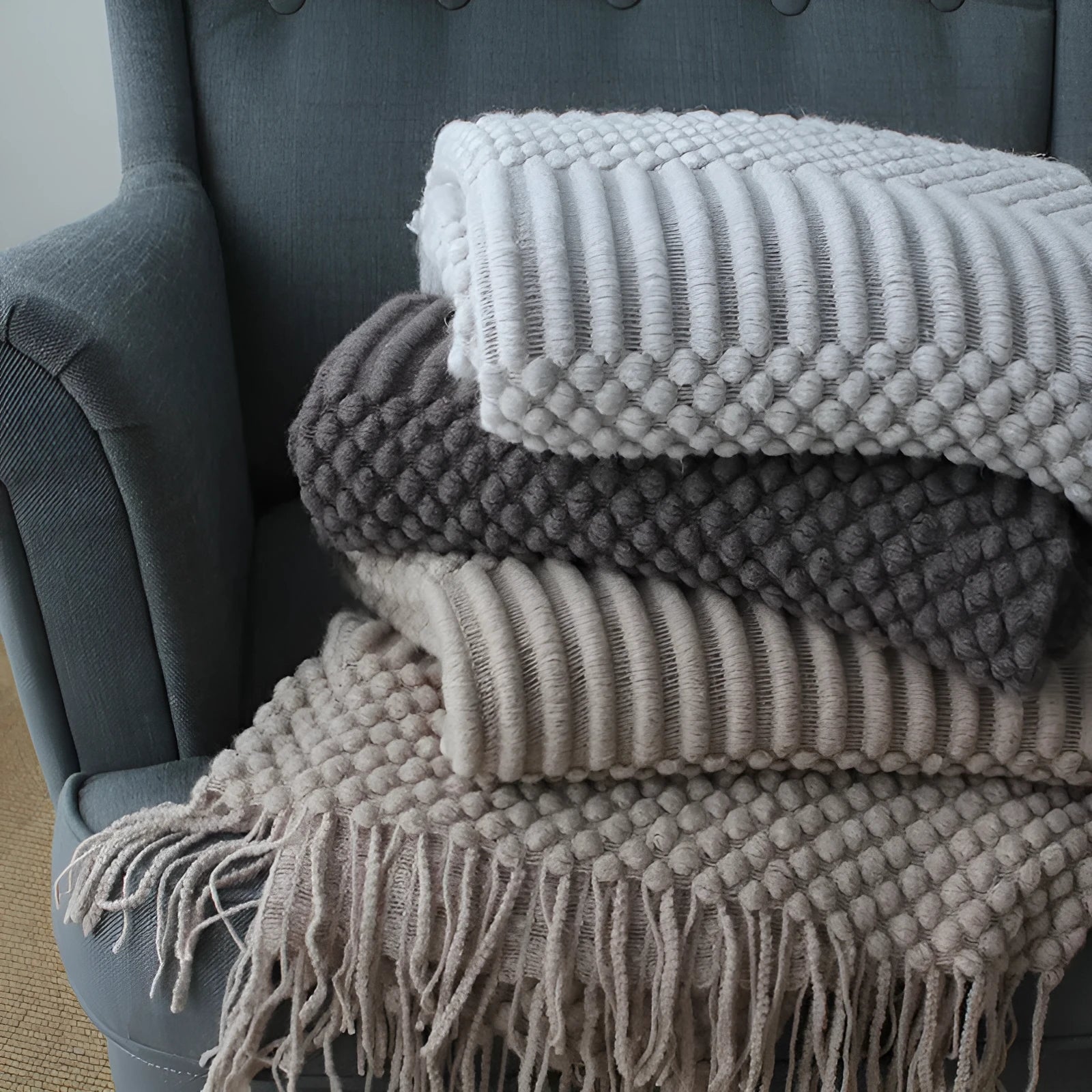 Small light grey polyester nap blanket folded, showing its texture and 127x170 cm size.