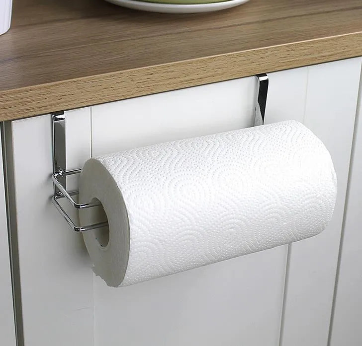 Silver stainless steel kitchen towel rack hanging on a cabinet door.