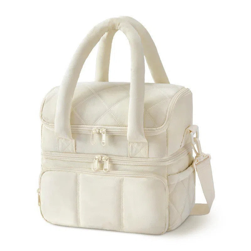 Double-layer insulated quilted pufferfish lunch bag in pink with curved shoulder straps and patchwork details
