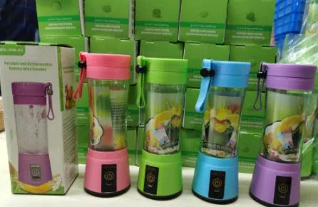Pink portable USB rechargeable blender with 380ml cup on a table next to fruits.