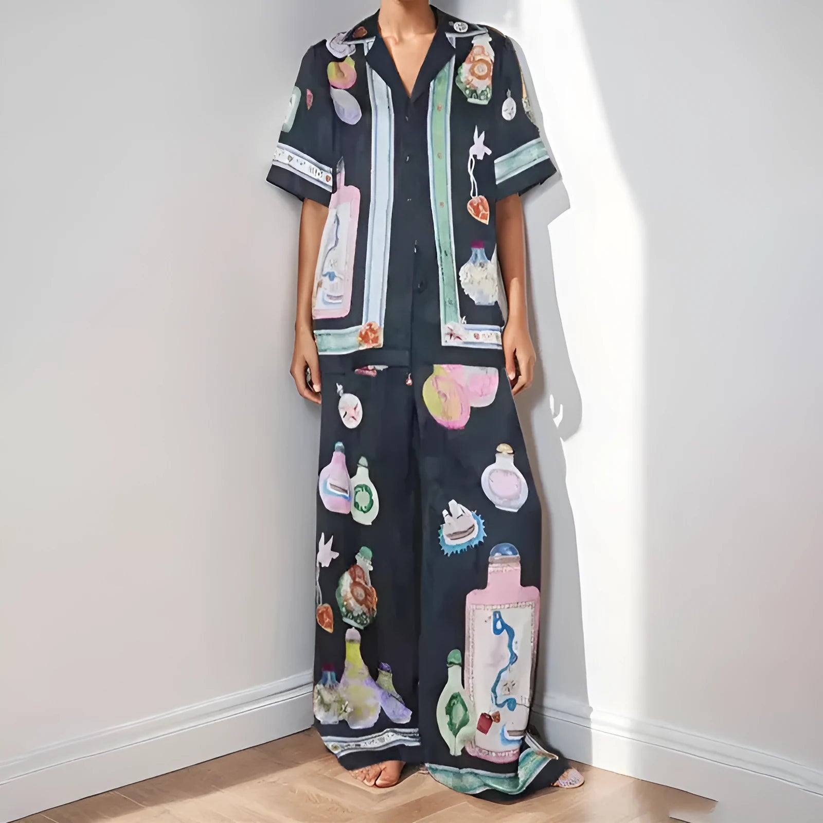 Black women's two-piece cardigan and trousers set with a cartoon animation pattern print.