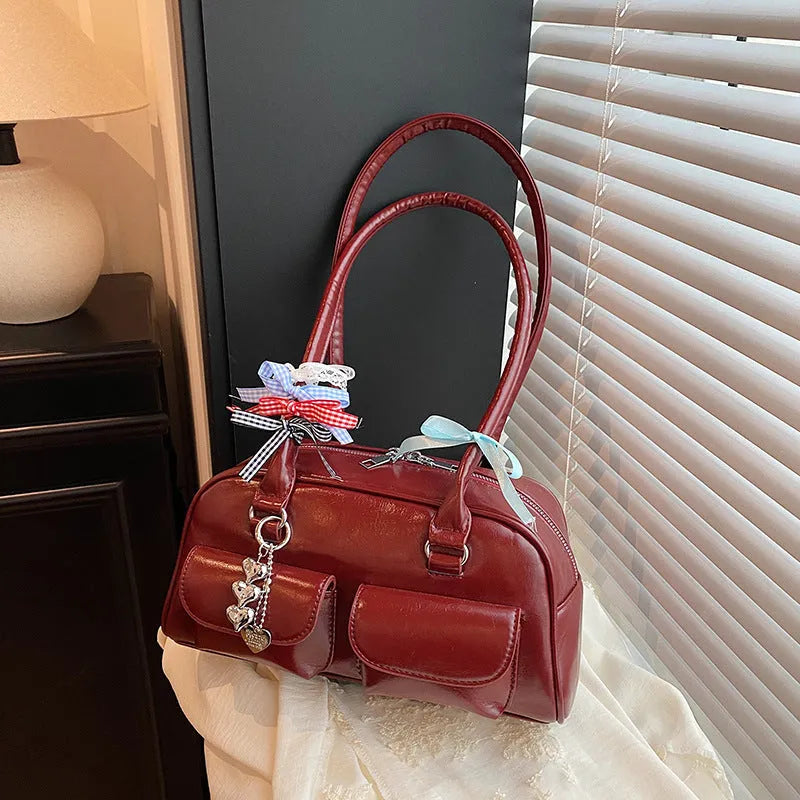 Women's brown PU leather retro pillow handbag with flap and ribbon pendant carried on shoulder