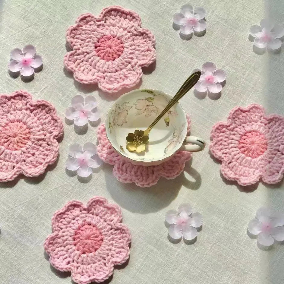 Circular handwoven wool coaster on a wooden table