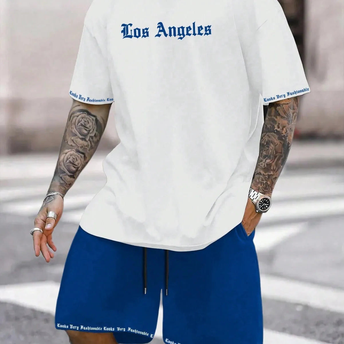 Man wearing a blue printed short-sleeve top and matching shorts from a quick-dry sports set.