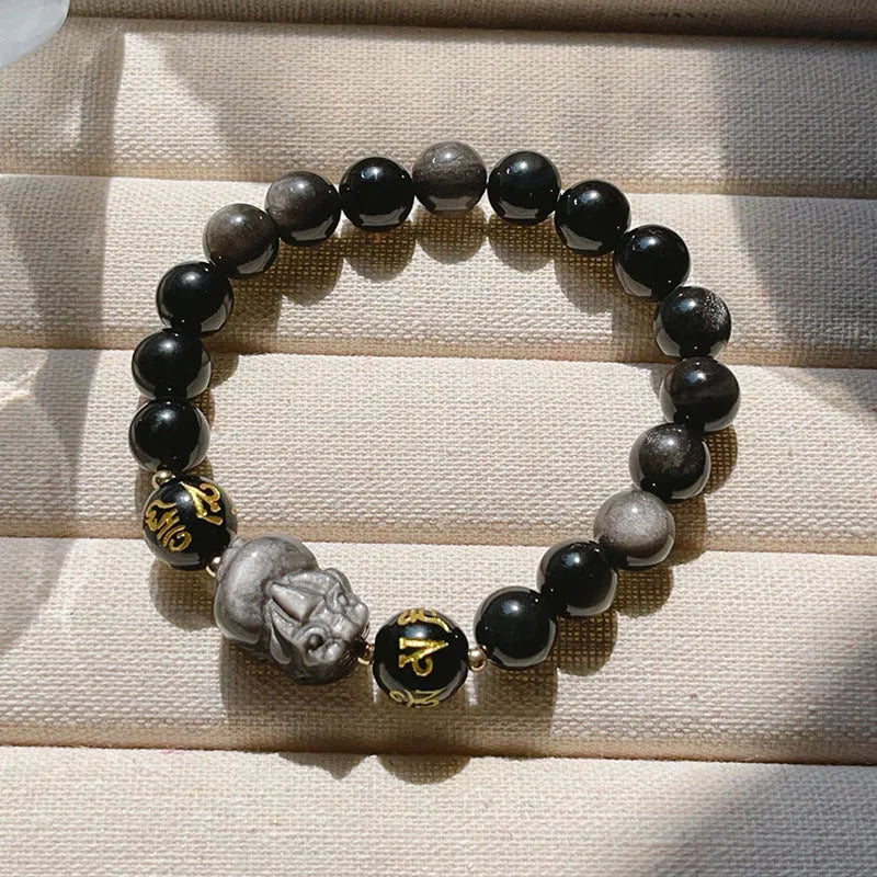 Men's silver stone beaded bracelet with zodiac and Chinese proverb charms on a wrist.