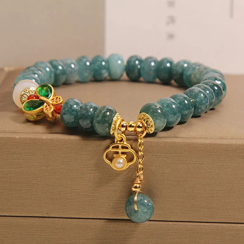 Women's blue water jade abacus bead bracelet with alloy inlay and white agate accents