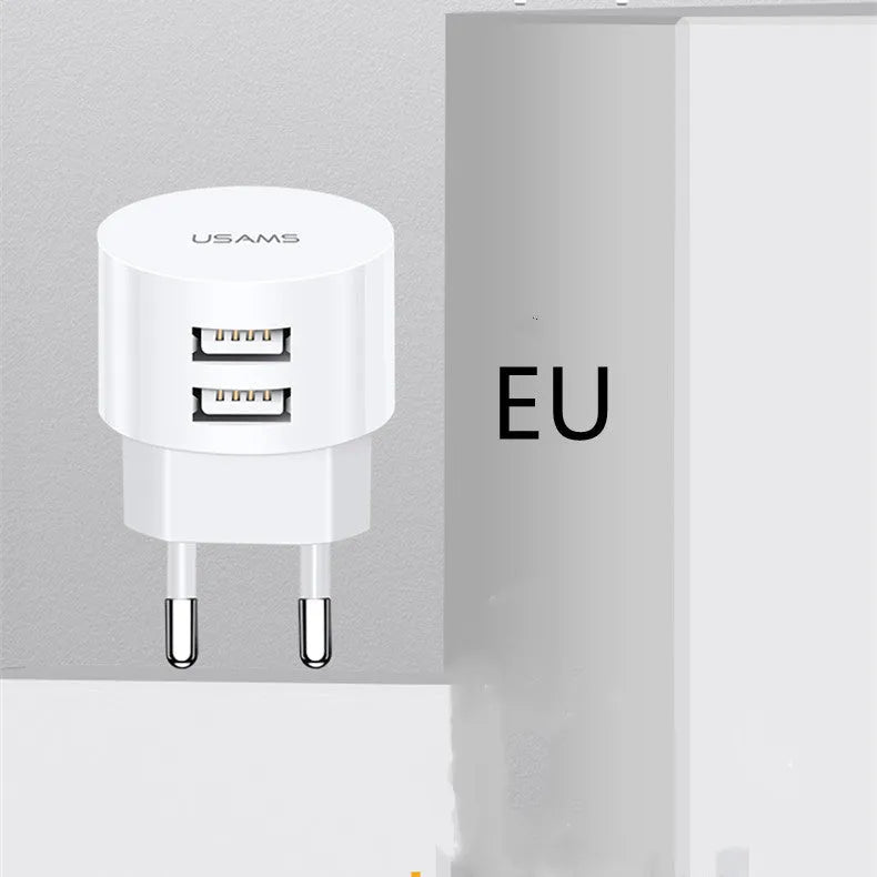White universal USB phone charger with foldable US, UK, and EU plugs showing compact design
