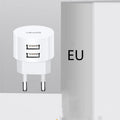 White universal USB phone charger with foldable US, UK, and EU plugs showing compact design