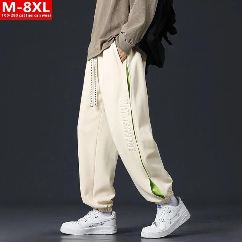 Men's loose cotton trousers with elasticated ankle bands and collage stitching details in khaki colour