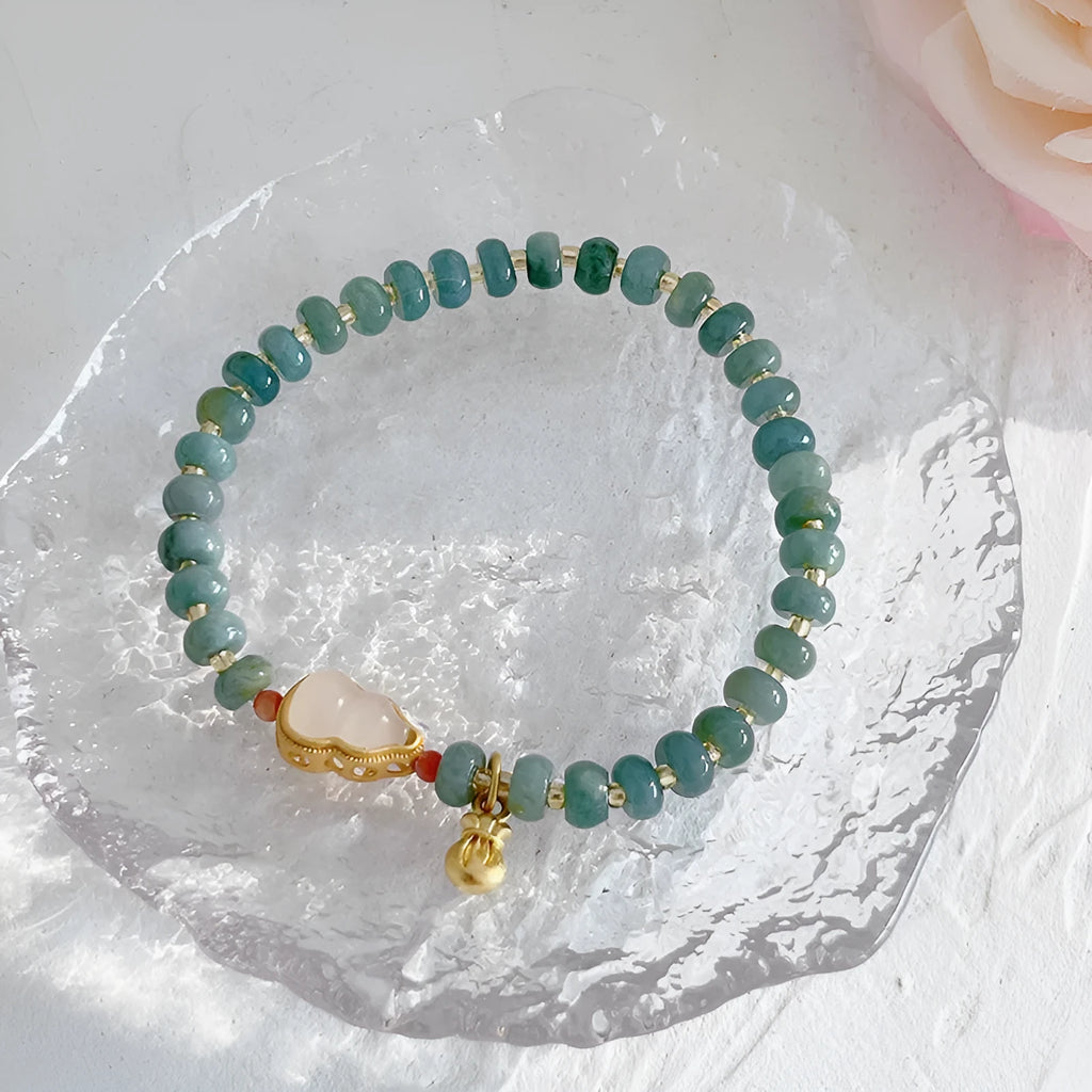 Natural blue water jade bracelet with gourd beads and peace buckle charm on woman's wrist