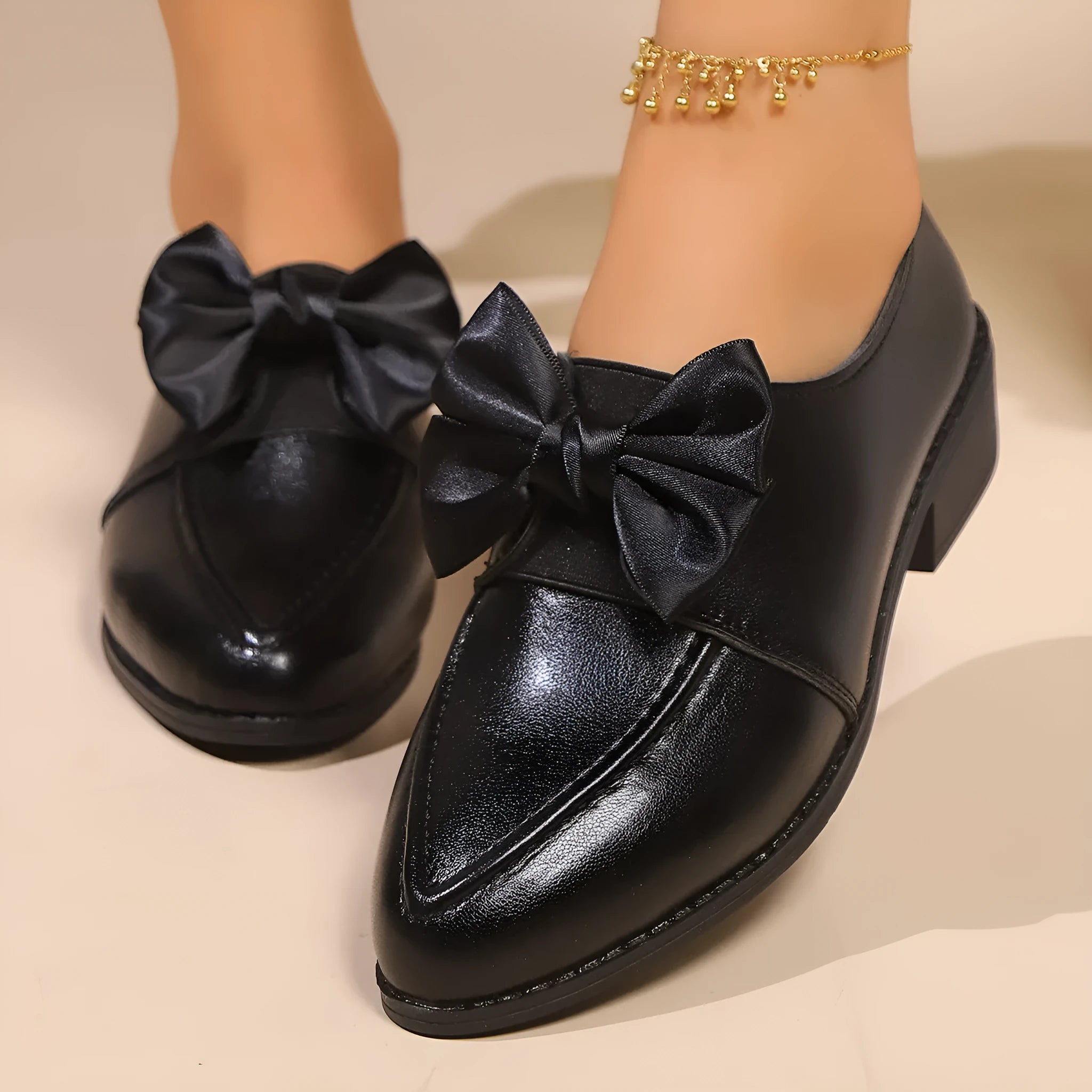 Women's British-style leather shoes with bow decoration, pointed toe, and slip-on design