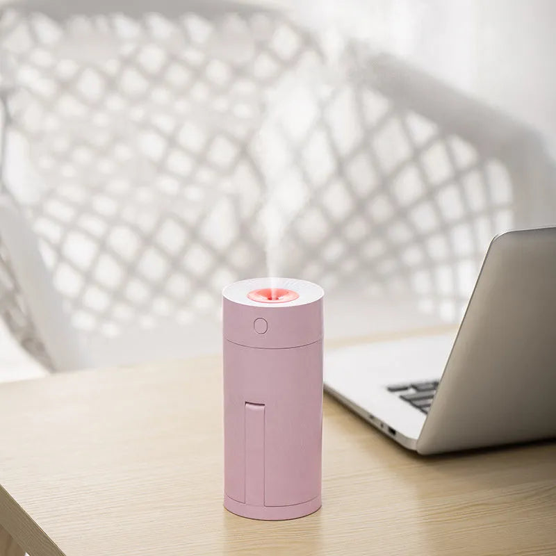 Compact white folding bracket USB desktop humidifier on a wooden desk