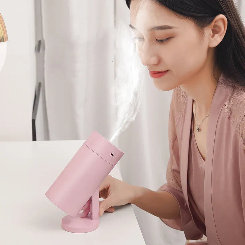 Compact white folding bracket USB desktop humidifier on a wooden desk