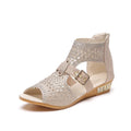 Women's flat sandals with wedge heel, back zipper and decorative rivet details on artificial PU upper