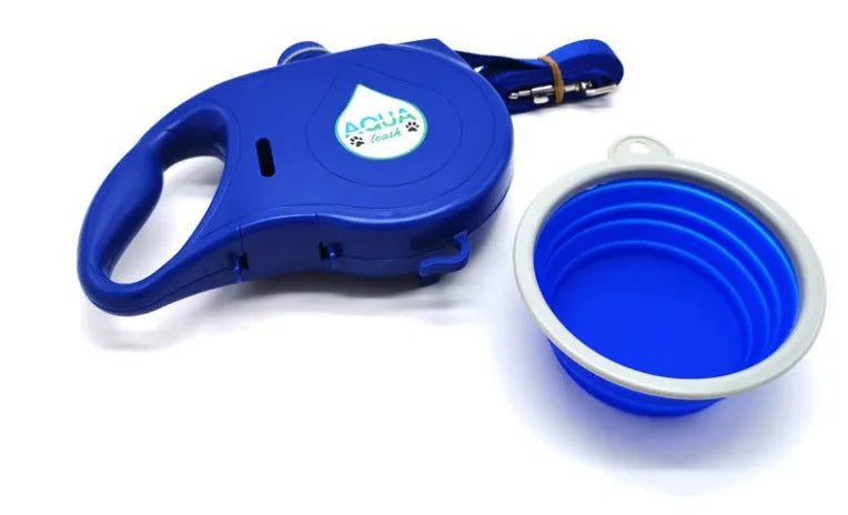 Blue retractable dog leash with ergonomic handle and silicone folding bowl on grass