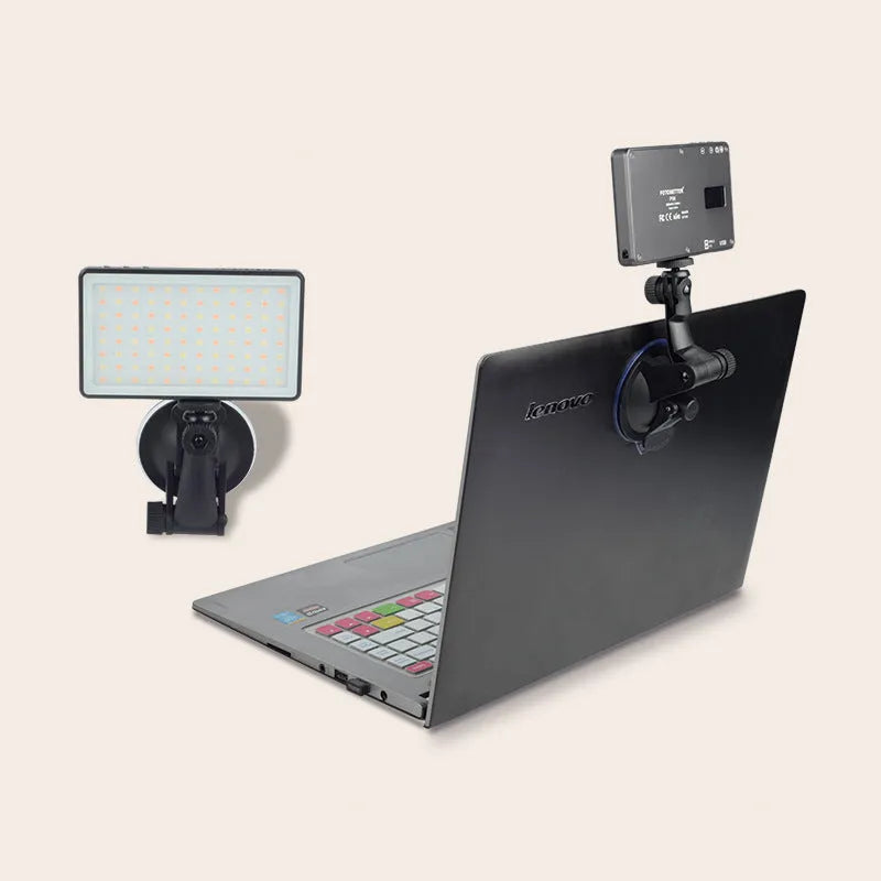Black portable LED video light for laptop with display screen and USB-C port, shown mounted on a tripod.
