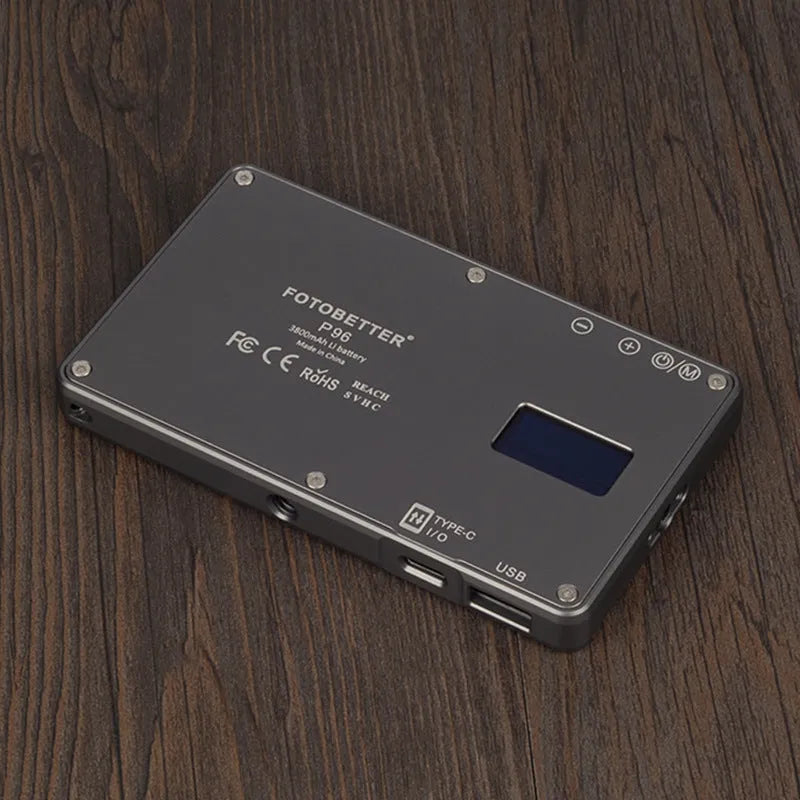 Black portable LED video light for laptop with display screen and USB-C port, shown mounted on a tripod.