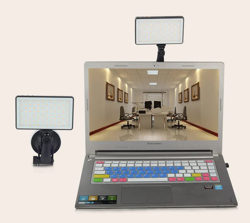 Black portable LED video light for laptop with display screen and USB-C port, shown mounted on a tripod.