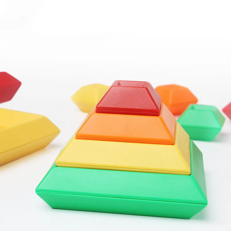 Rainbow coloured plastic building blocks forming educational towers for children's cognitive development