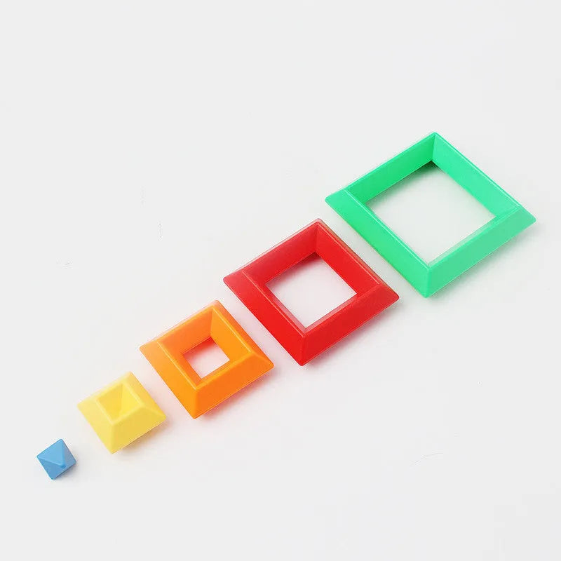 Rainbow coloured plastic building blocks forming educational towers for children's cognitive development