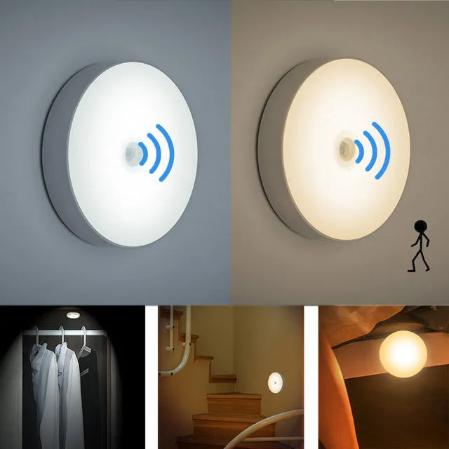 Small circular beige and white LED body sensor night light with USB charging cable on a surface.