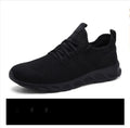 Men's black and white mesh lace-up sneakers with round toe and PVC sole.