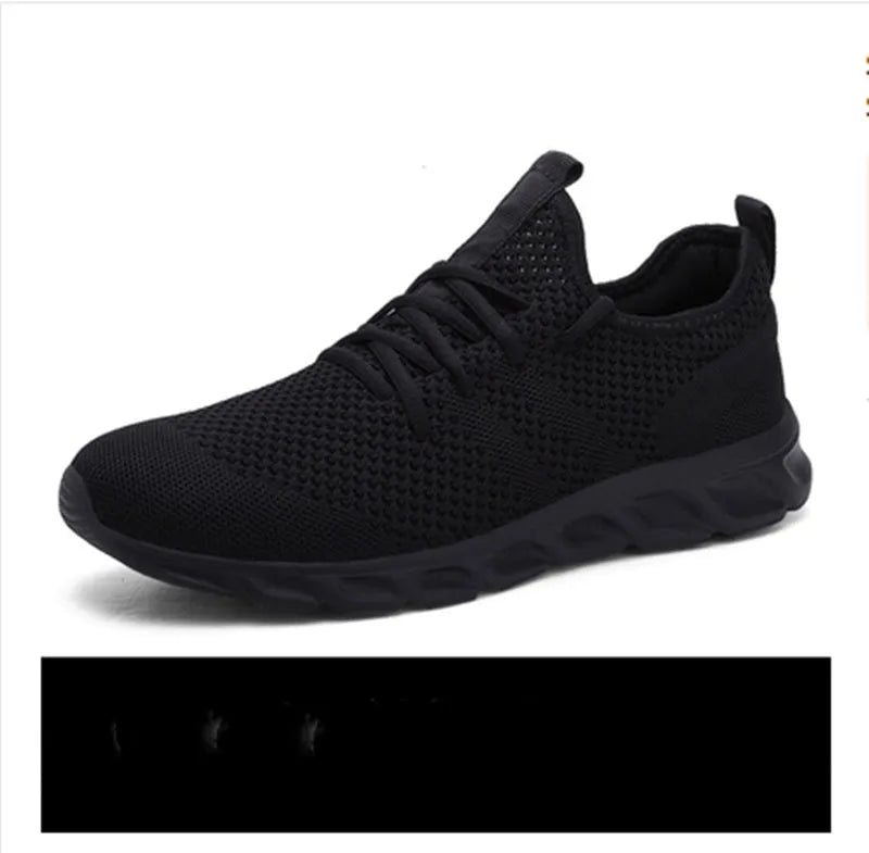 Men's black and white mesh lace-up sneakers with round toe and PVC sole.