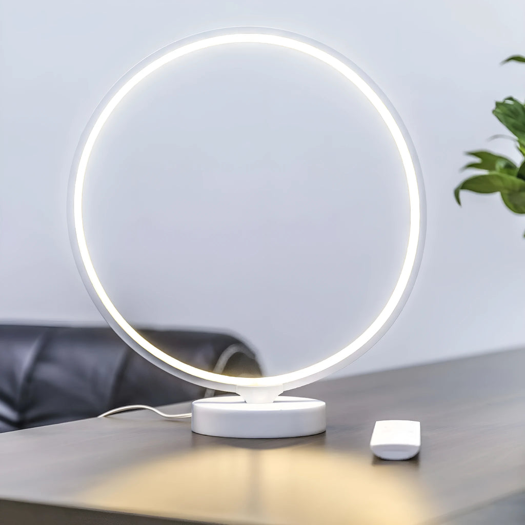 White spherical Full Moon table lamp with remote control on a wooden surface.