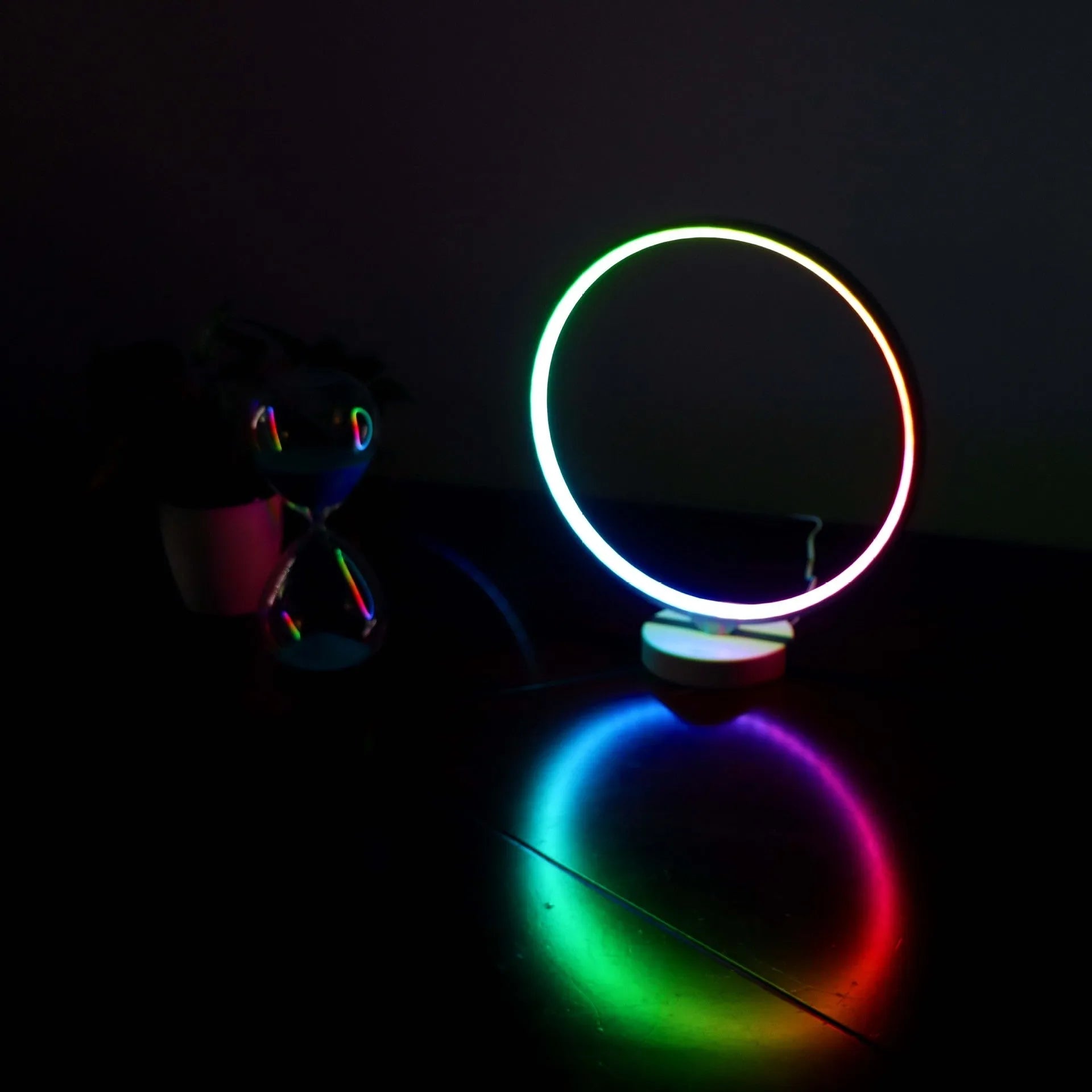 White spherical Full Moon table lamp with remote control on a wooden surface.