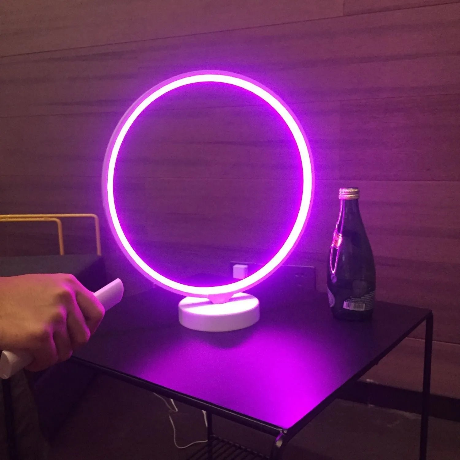 White spherical Full Moon table lamp with remote control on a wooden surface.