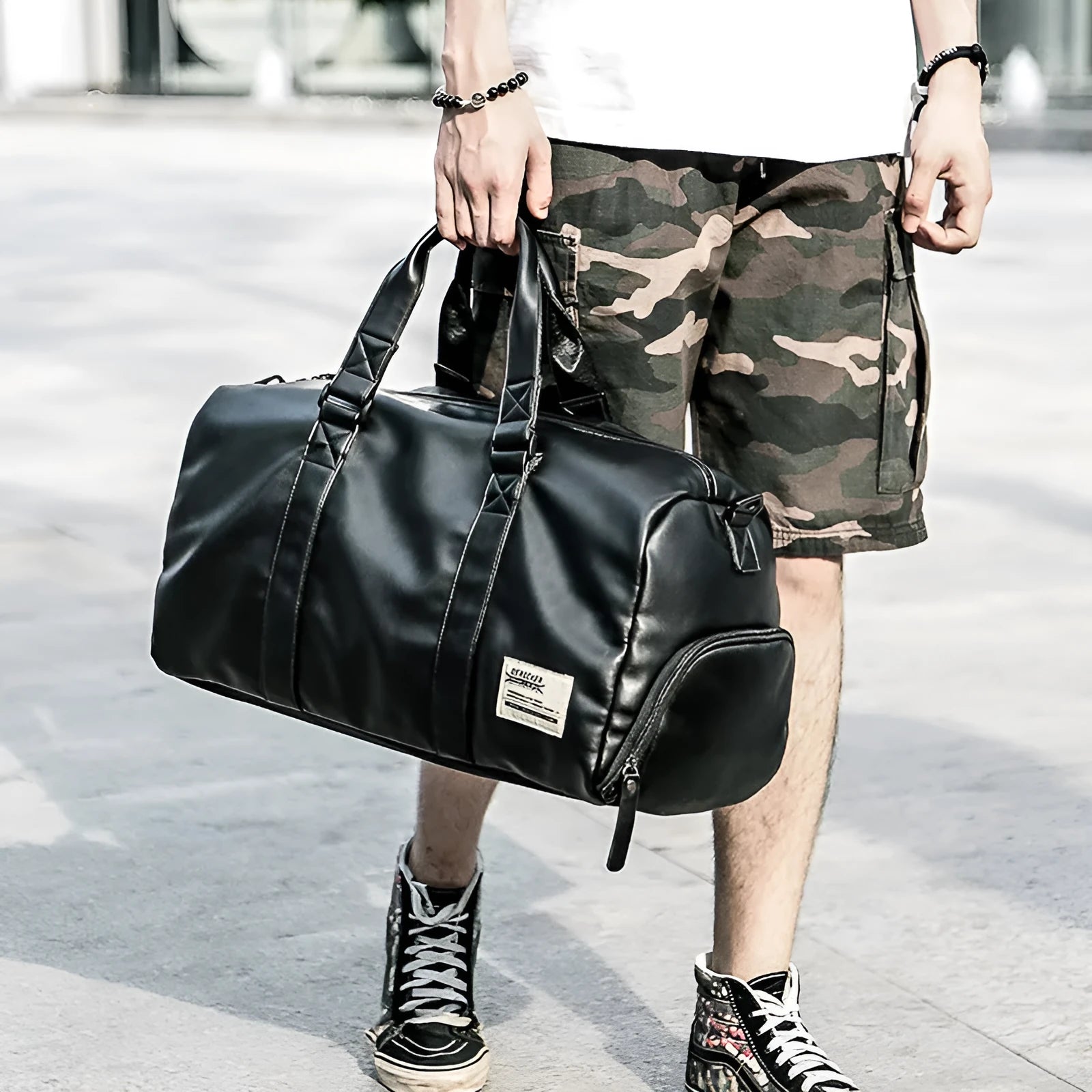 Black large capacity PU leather sports training bag with single strap and multiple internal pockets.
