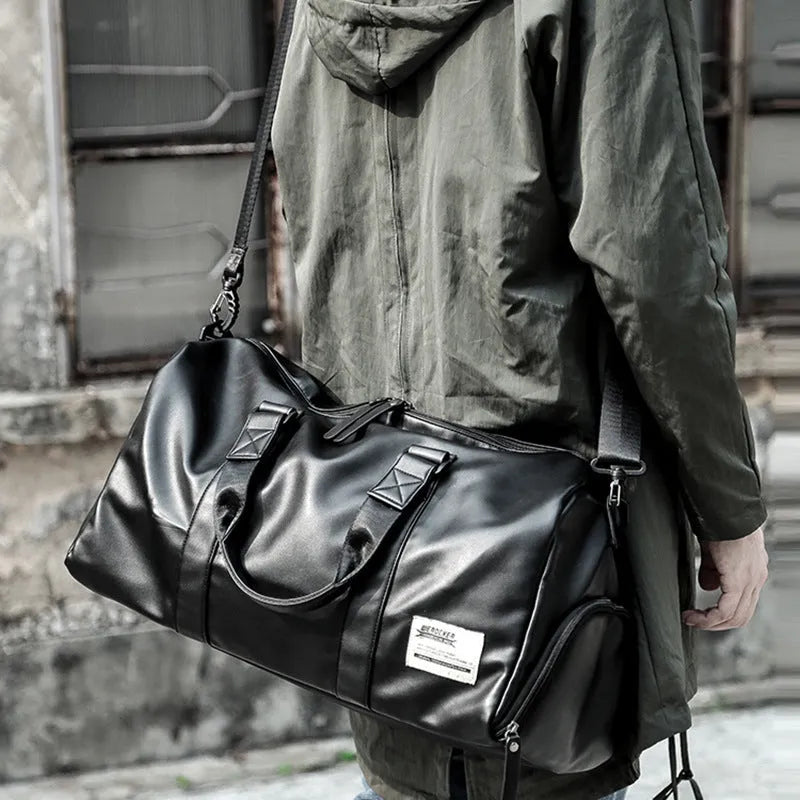 Black large capacity PU leather sports training bag with single strap and multiple internal pockets.