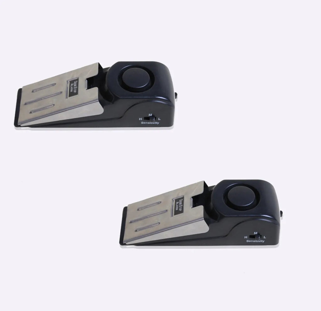 Black portable wedge-shaped door stop alarm with a stainless steel cover for home and travel security.