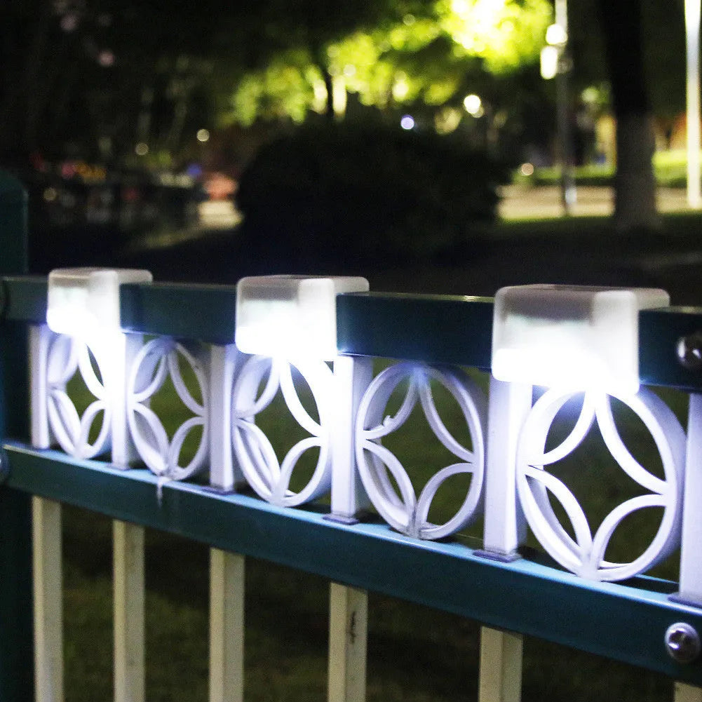 Four white solar railing lights for outdoor steps and fences with IP65 waterproof rating