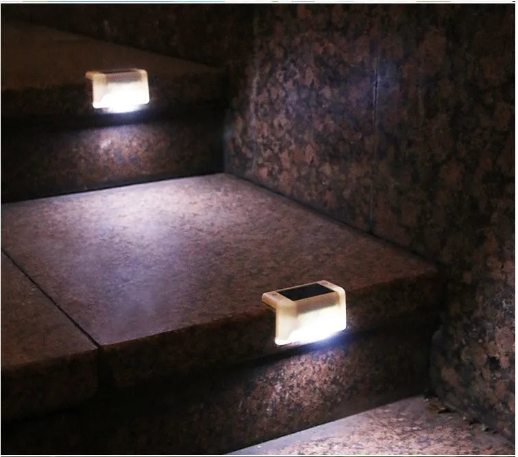 Four white solar railing lights for outdoor steps and fences with IP65 waterproof rating