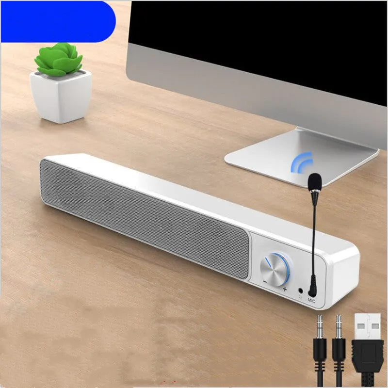 Black and white desktop computer speakers with ABS PC casing on wooden desk