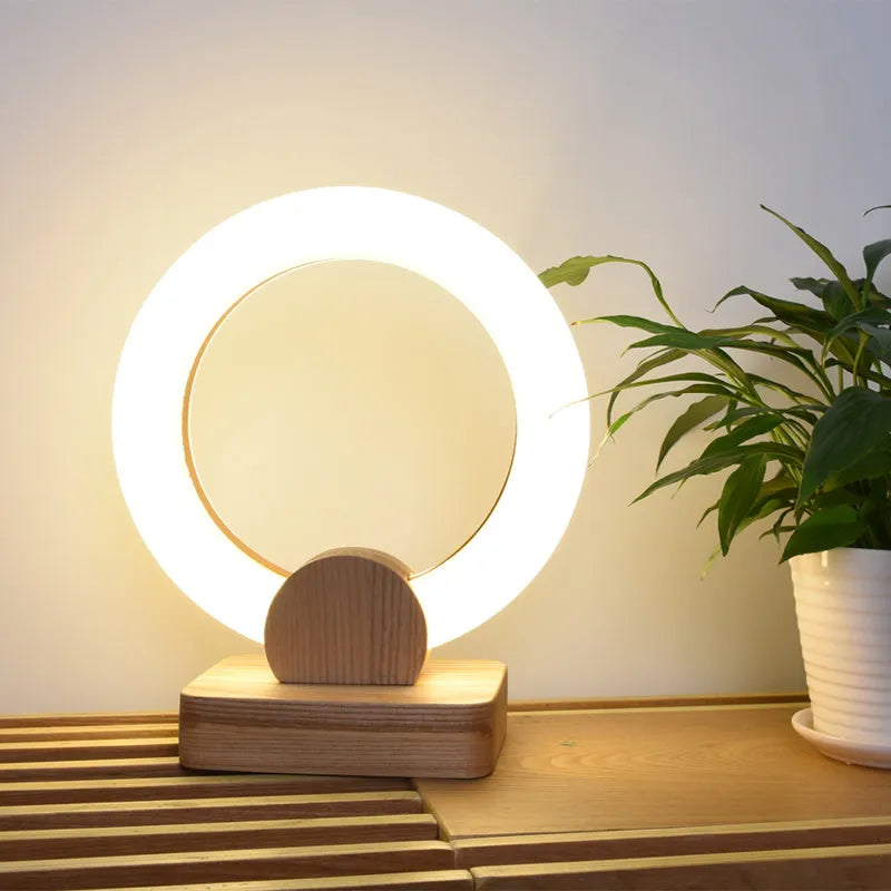 Nordic style circular wooden chandelier with a white acrylic shade hanging from a ceiling.