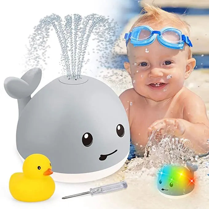 Grey whale bath toy spraying water with LED lights in baby bath