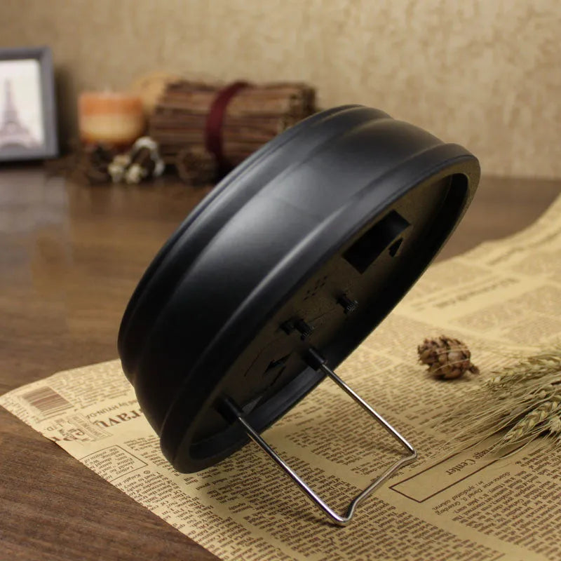 European retro style round desk clock with silent alarm on wooden table