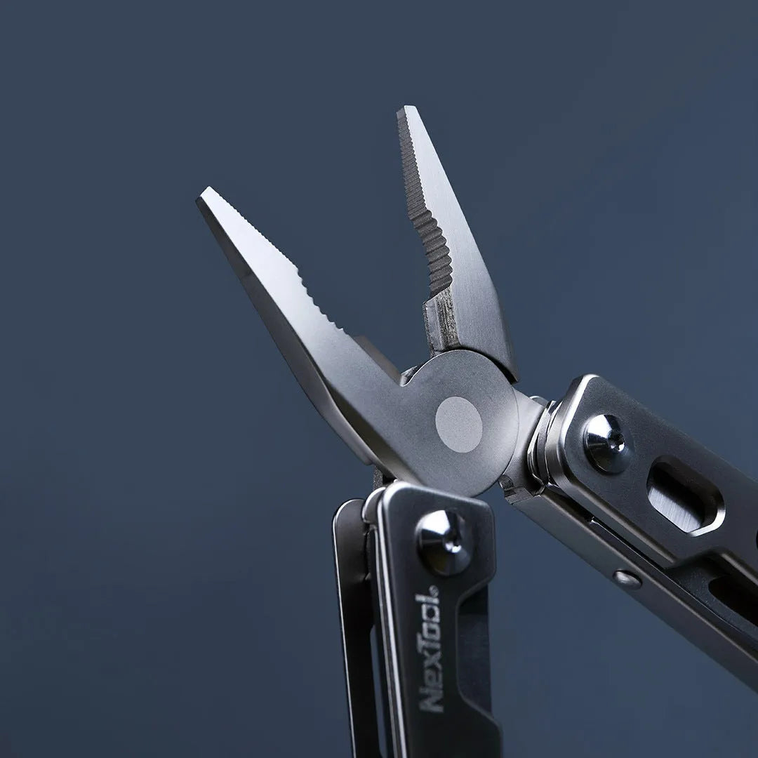 White stainless steel multi-function tool combining a wrench, knife, and needle-nose pliers