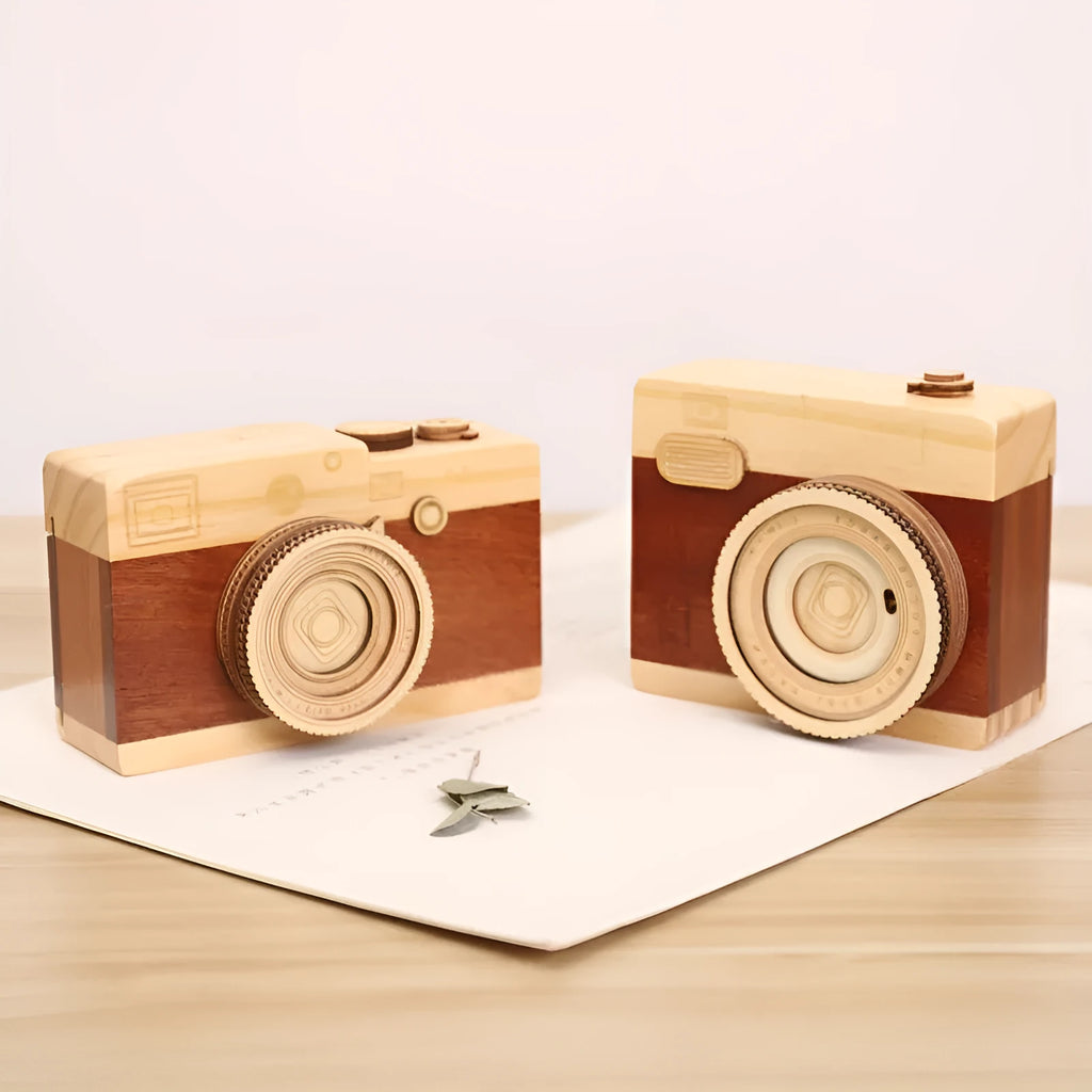 Camera-shaped wooden music box rotating on wooden surface with pine wood construction
